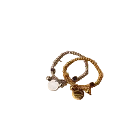 Bracelet with heart charm on a decorative card with 'Person of the Year' magazine in the background.