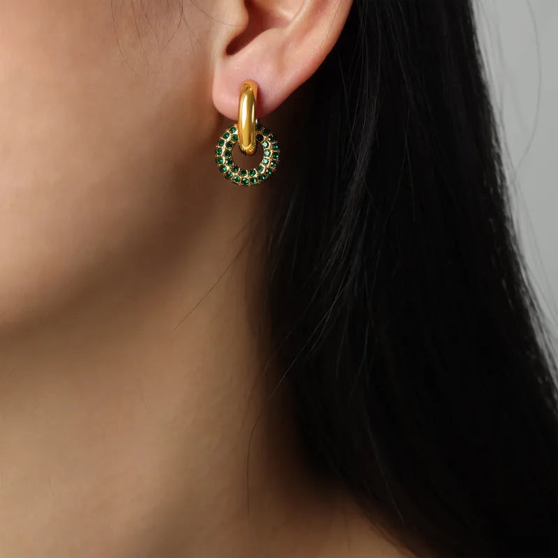 ear wearing small gold hoop with stone and 2 ear cuffs, one gold and one with stones