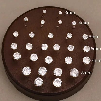 Set of 18k gold plated stud earrings in sizes 3mm to 8mm displayed on wooden holder