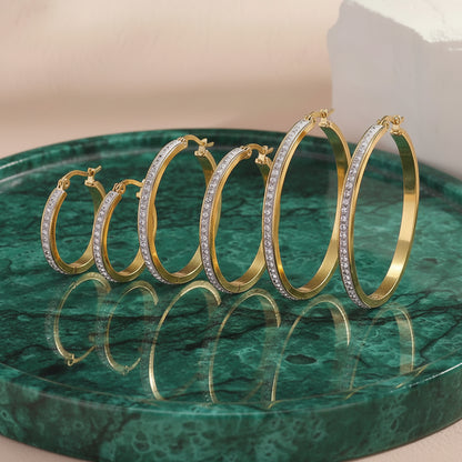 Set of 3 gold rhinestone hoops, small medium and large on beige background