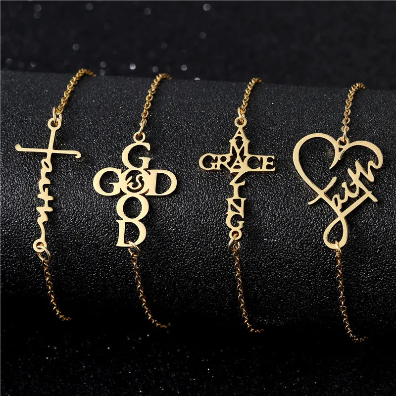 Four gold bracelets with religious-themed pendants on a black background