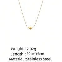 Gold necklace with a heart pendant with measurements on a white background