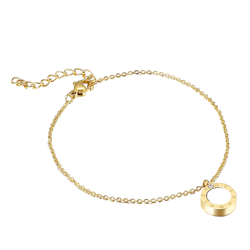 Gold bracelet with a white circular charm on a white background