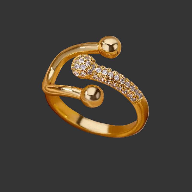 Gold 3 prong open ring with stone accents on a white background