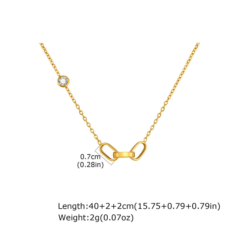 Gold necklace with a dainty 3 interlocked links pendant on a white background with measurements.