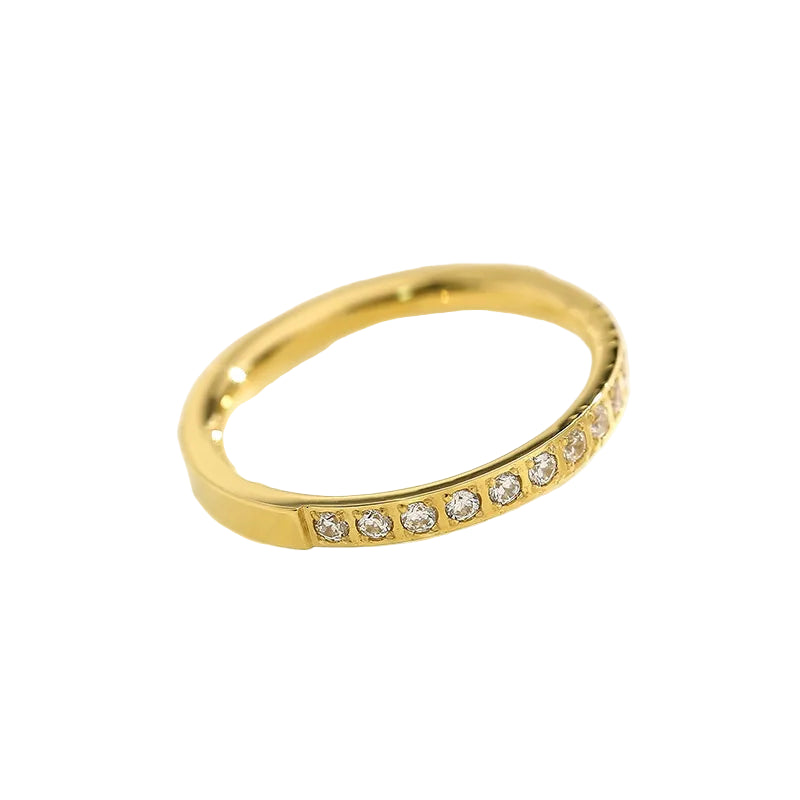 Gold ring with small diamonds on a light background