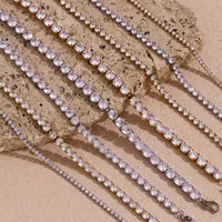 Set of gemstone bracelets on a stone and beige background
