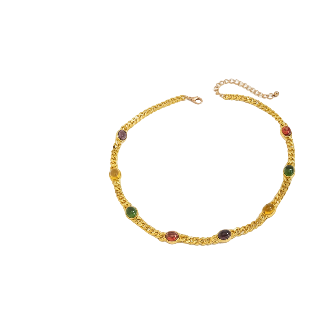 gold necklace with gemstones on white background