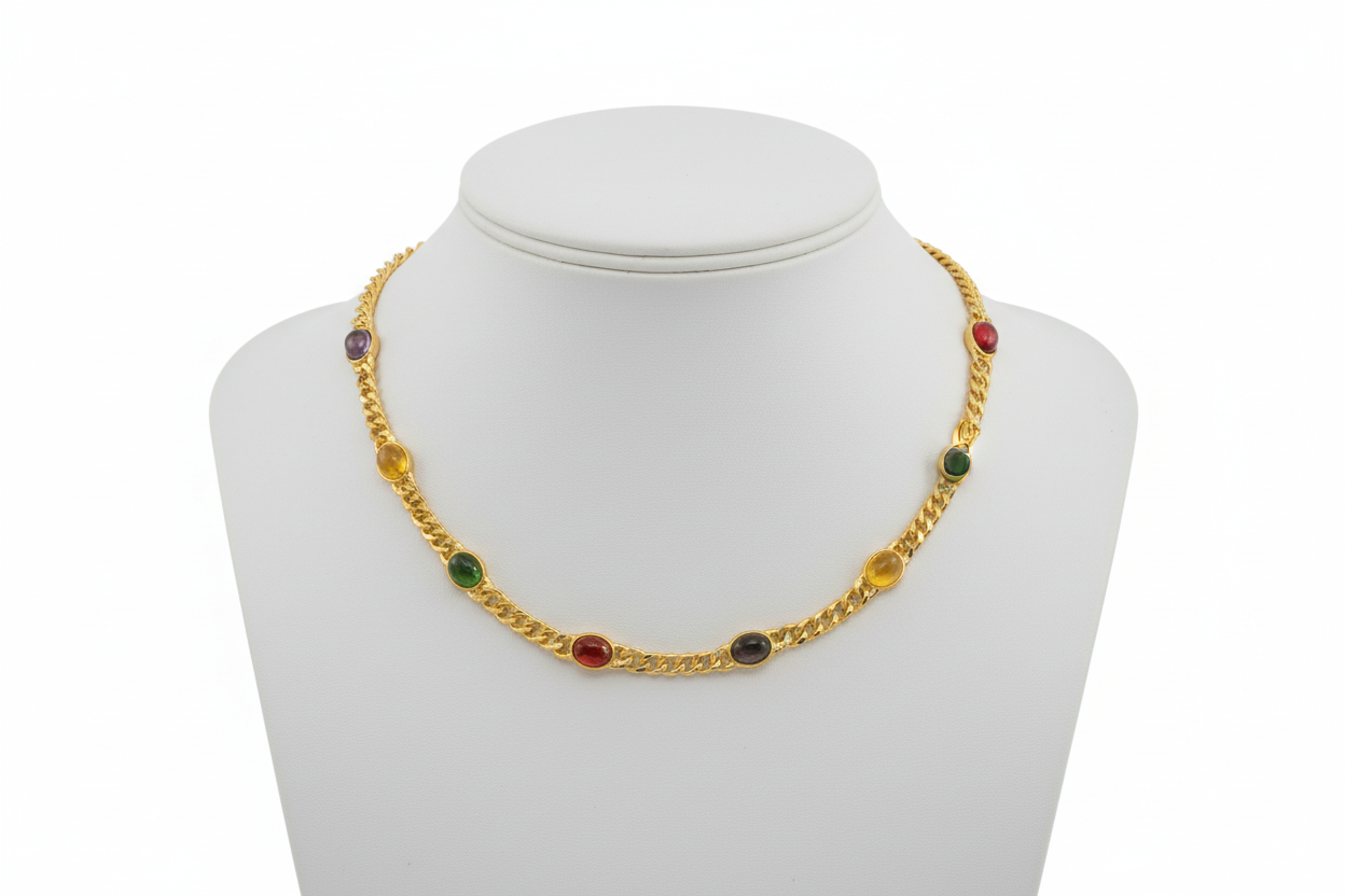Gold necklace with colored beads on a white mannequin bust