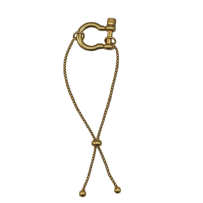 Gold horseshoe lock bracelet on a white background