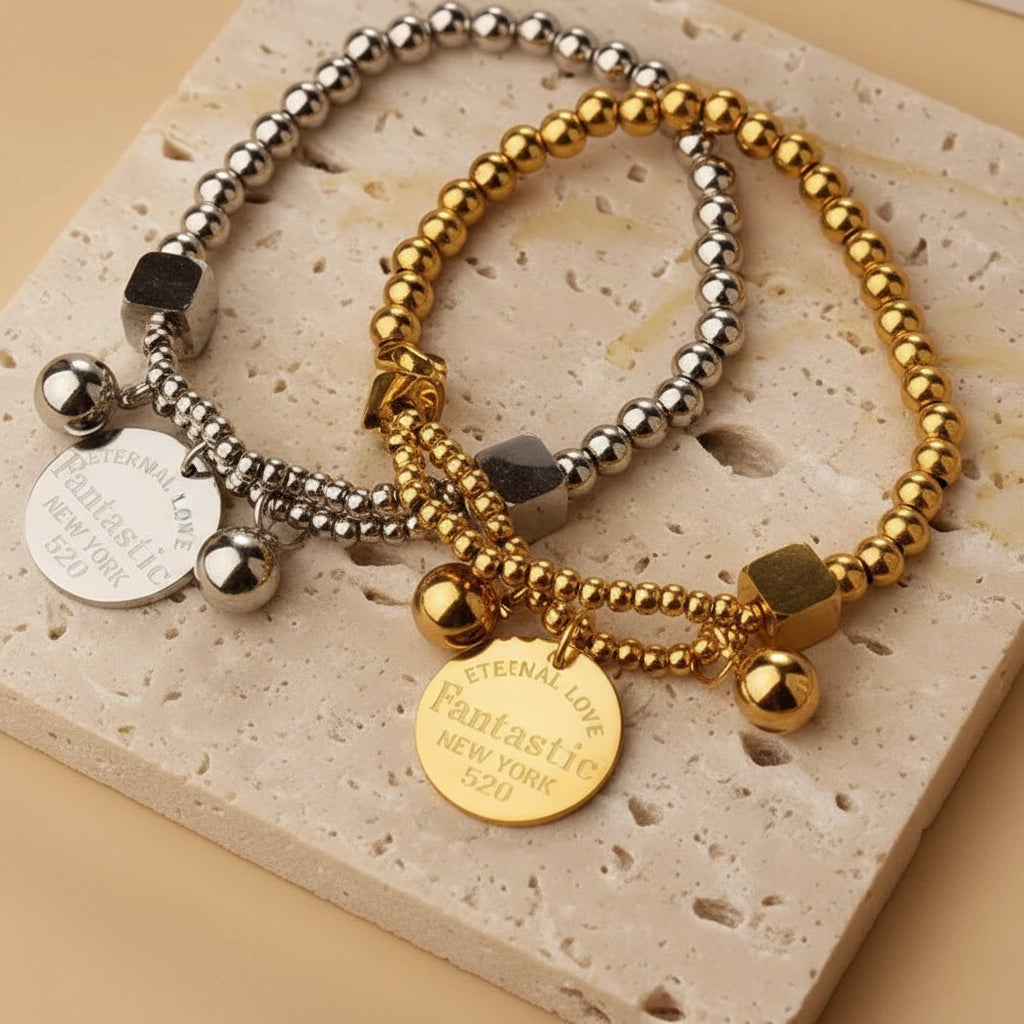 Two beaded bracelets with coins on a stone surface with 'Person of the Year' text in the background.