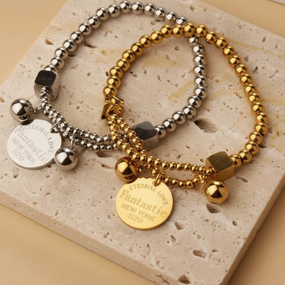 Two beaded bracelets with coins on a stone surface with 'Person of the Year' text in the background.