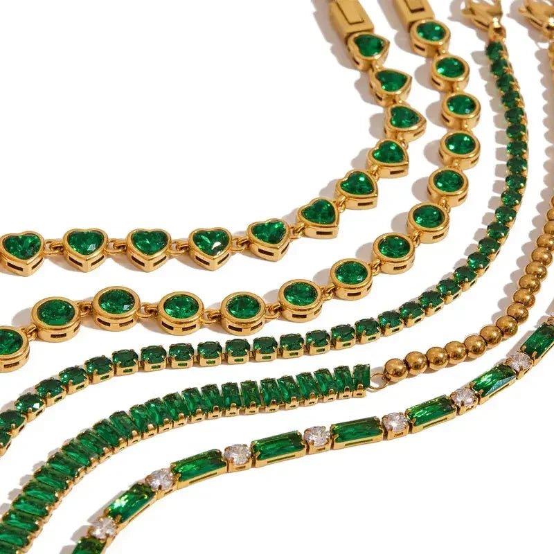 Gold bracelets with green gemstones including heart, round, and rectangular shapes by Metal Content