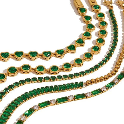 Gold bracelets with green gemstones including heart, round, and rectangular shapes by Metal Content
