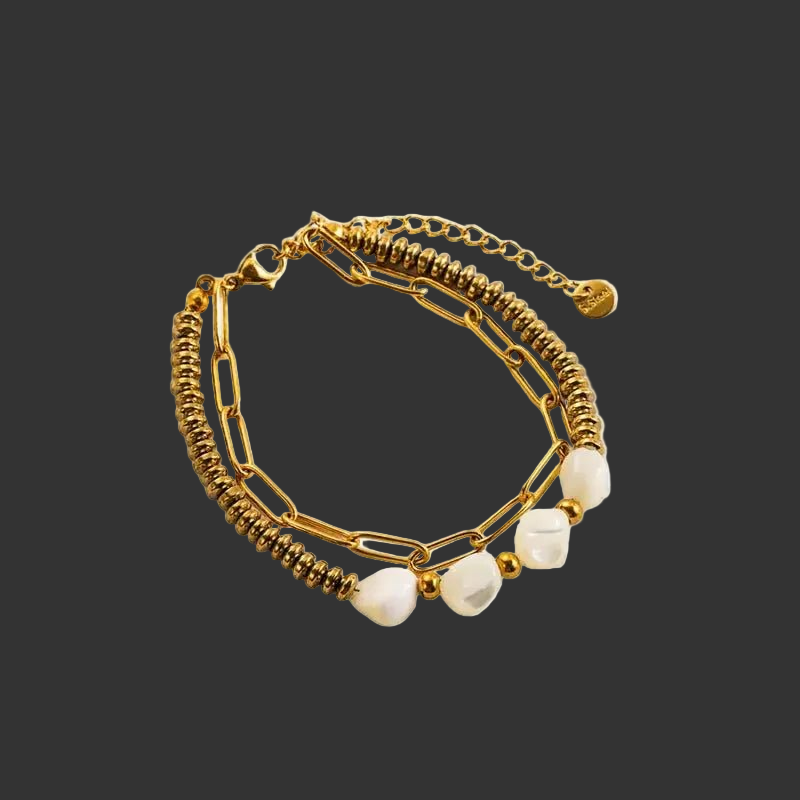 Gold bracelet with one chain of links and one of tiny circle links and white beads on a black background