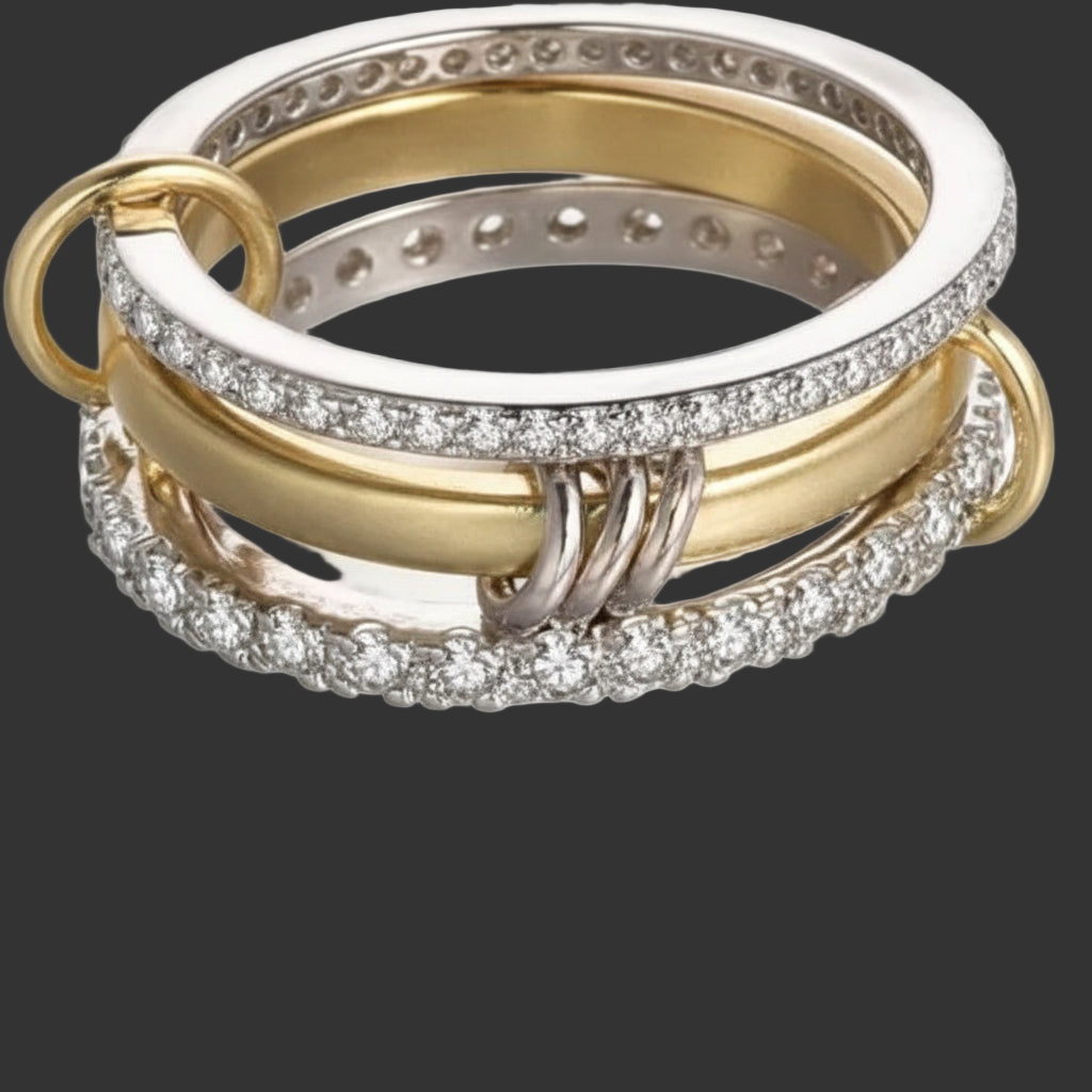 Three interlocking rings, two gold and one silver, with CZ accents on a black background.