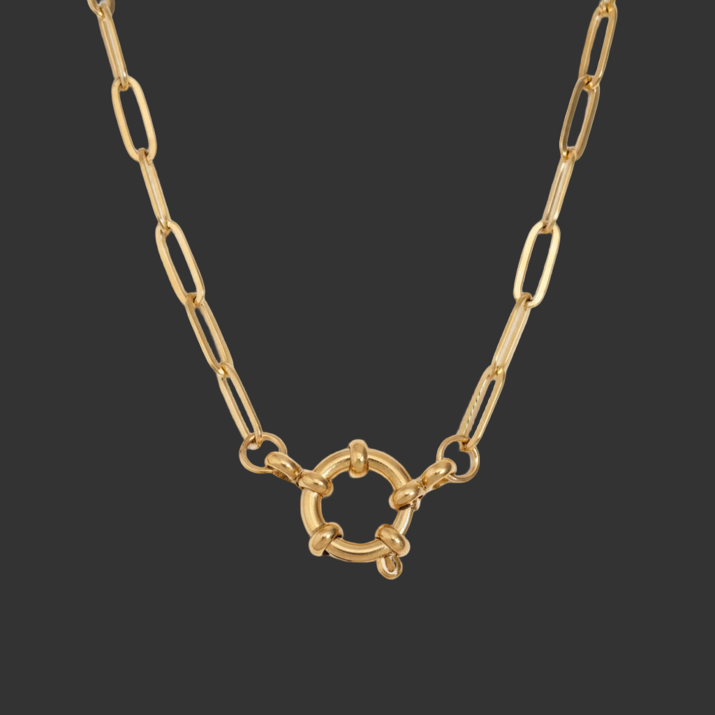 gold spring clasp pendant on paperclip link chain on black background