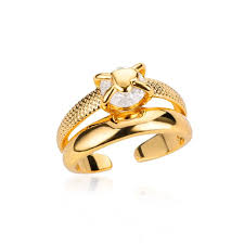 Gold ring with a heart-shape over gemstone on a white background