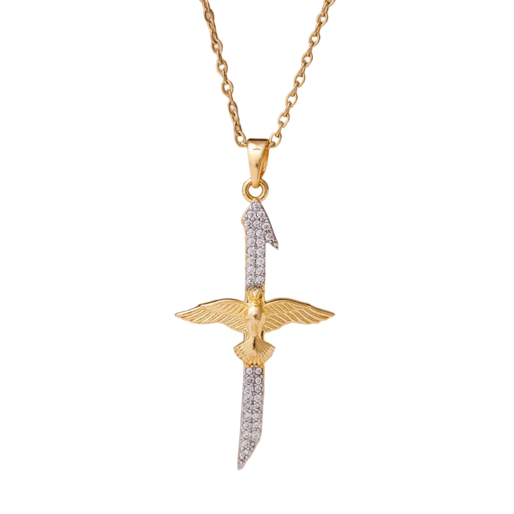 silver and gold tone dove cross pendant necklace on white background