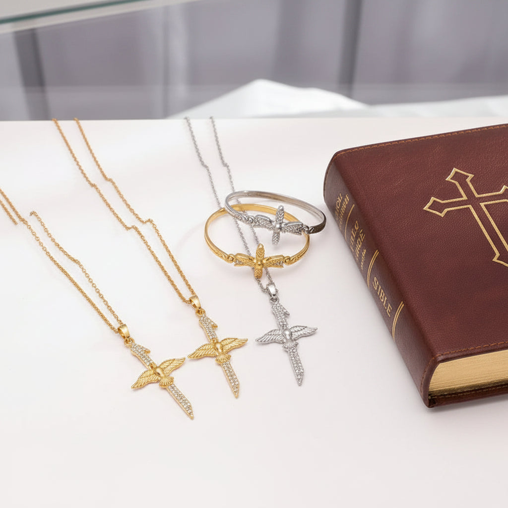 dove cross necklaces in gold, silver and mixed metal on white table with 1 gold and 1 silver bangle and Holy Bible