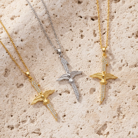 dove cross necklaces in gold, silver and mixed metal on neutral limestone