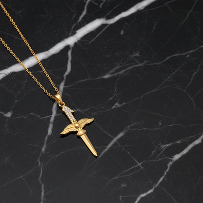 dove cross necklaces in gold and silver on black marble background