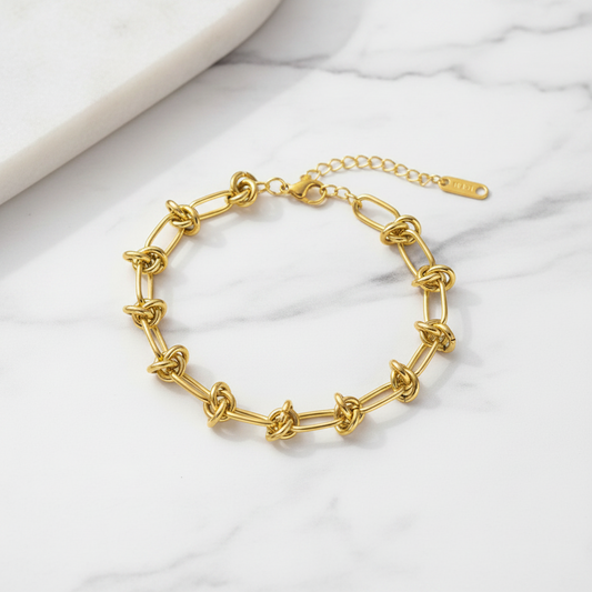 Gold chain bracelet on a white background