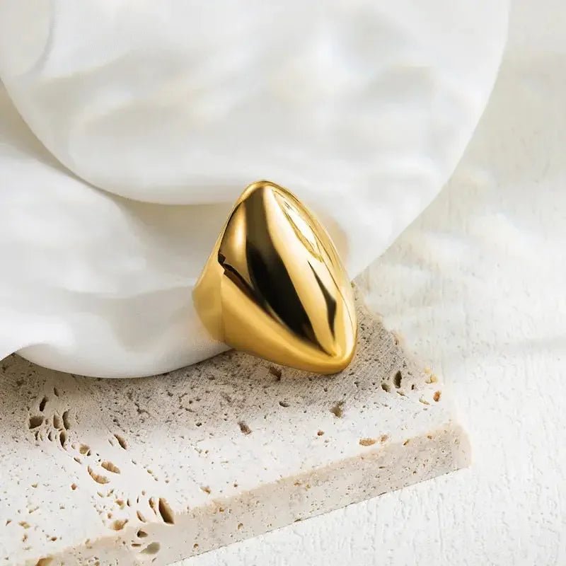 Long Dome Ring 18K Gold Plated on white fabric and stone table