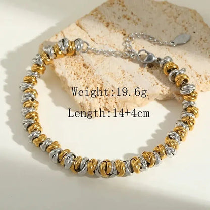 Women's Bracelet 18K Gold Plated Stainless Steel Mixed Metal Link with measurements sitting on piece of neutral marble