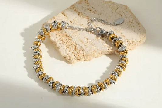 Women's Bracelet 18K Gold Plated Stainless Steel Mixed Metal Link with measurements sitting on piece of neutral marble