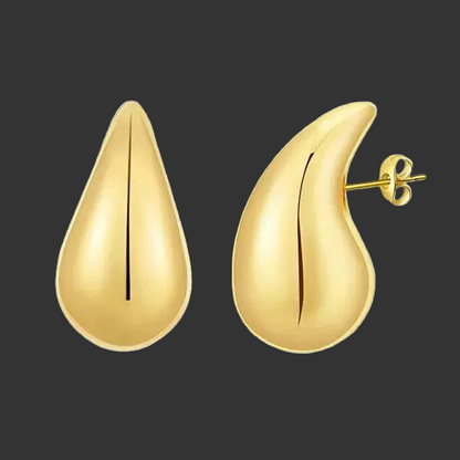 Large gold teardrop-shaped earrings on a black background